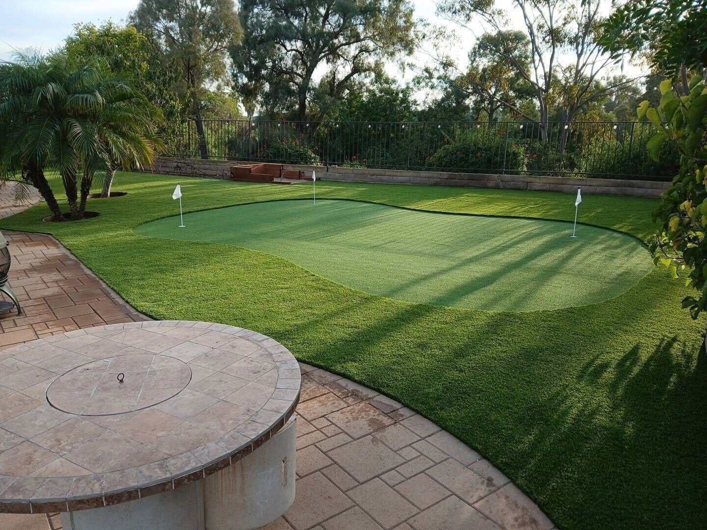 Freshly installed backyard turf putting green & pavers in San Diego, CA
